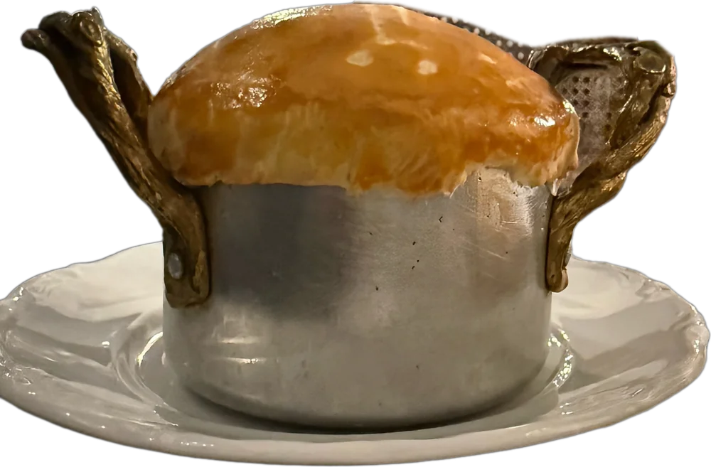 A small pot baked under a golden pastry lid