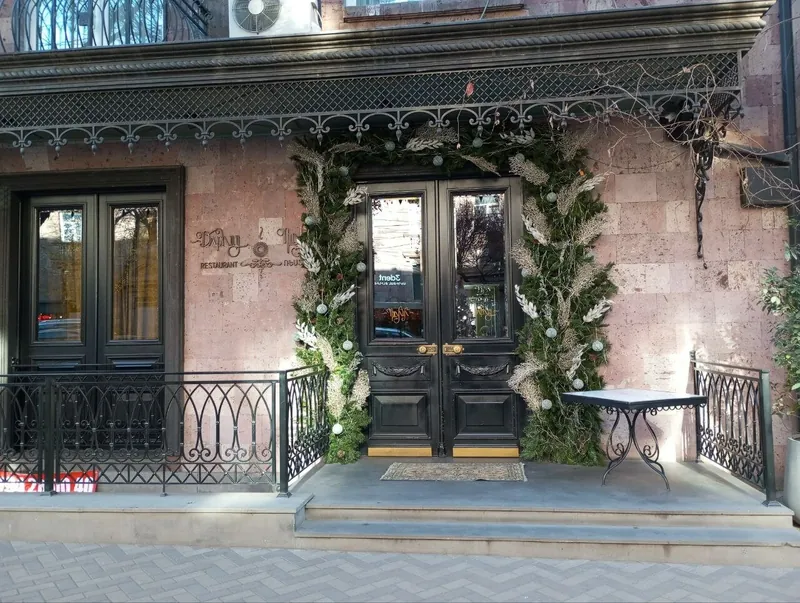Black double doors under a wrought-iron canopy