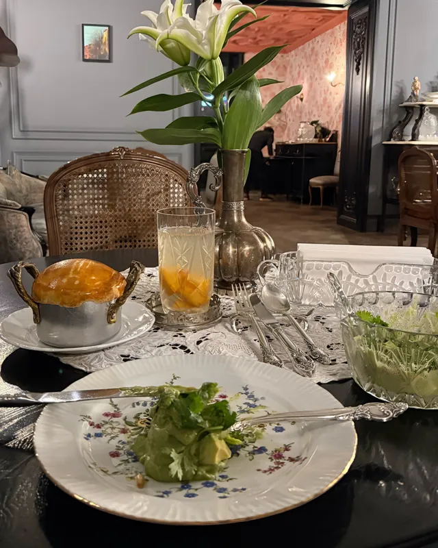 An evening table with lilies, crystal and floral plates